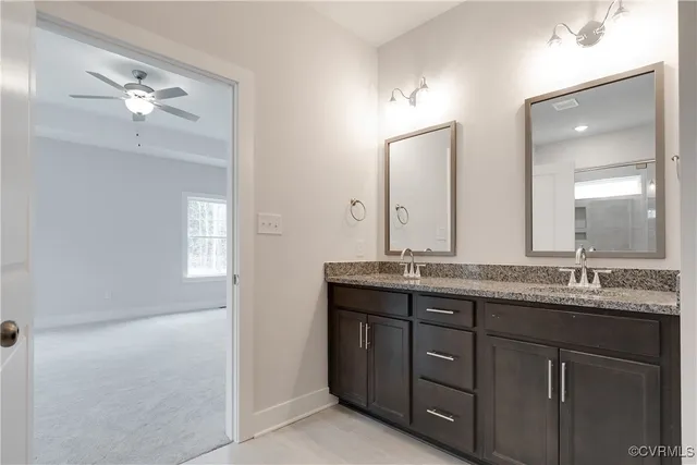 a bathroom with a granite countertop sink a large mirror and a