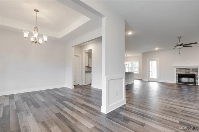 a view of empty room with wooden floor fireplace and window