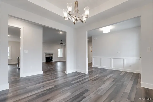 a view of an empty room and wooden floor