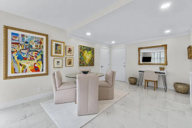 a living room with furniture and a wall painting