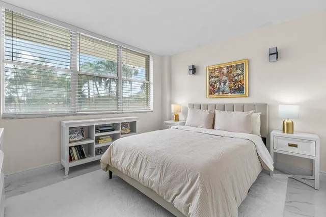 a bedroom with a bed next to a window