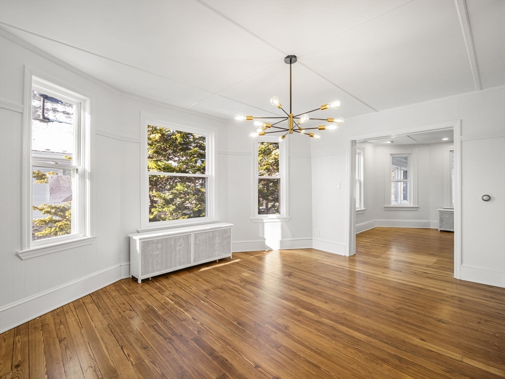 224 Pelham Street Methuen, MA 01844 - Photo 17 of 40 a view of an empty room with window and wooden floor