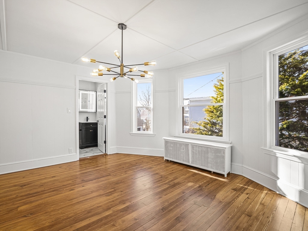 224 Pelham Street Methuen, MA 01844 - Photo 18 of 40 a view of an empty room with a window and wooden floor