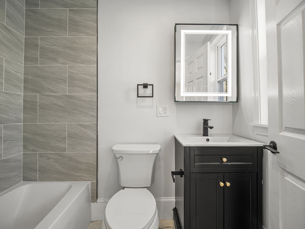 224 Pelham Street Methuen, MA 01844 - Photo 21 of 40 a bathroom with a toilet a sink and mirror