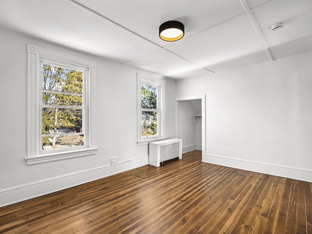 224 Pelham Street Methuen, MA 01844 - Photo 24 of 40 an empty room with wooden floor and windows