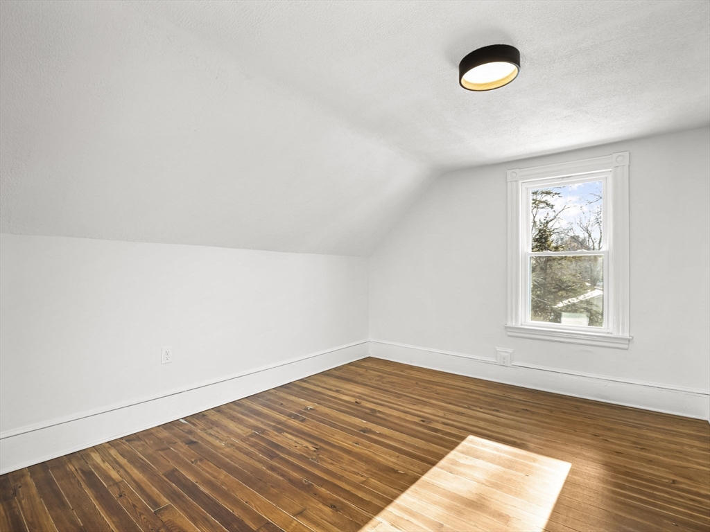 224 Pelham Street Methuen, MA 01844 - Photo 25 of 40 an empty room with wooden floor and windows