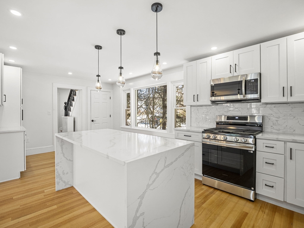 224 Pelham Street Methuen, MA 01844 - Photo 9 of 40 a kitchen with stainless steel appliances granite countertop a stove and a sink