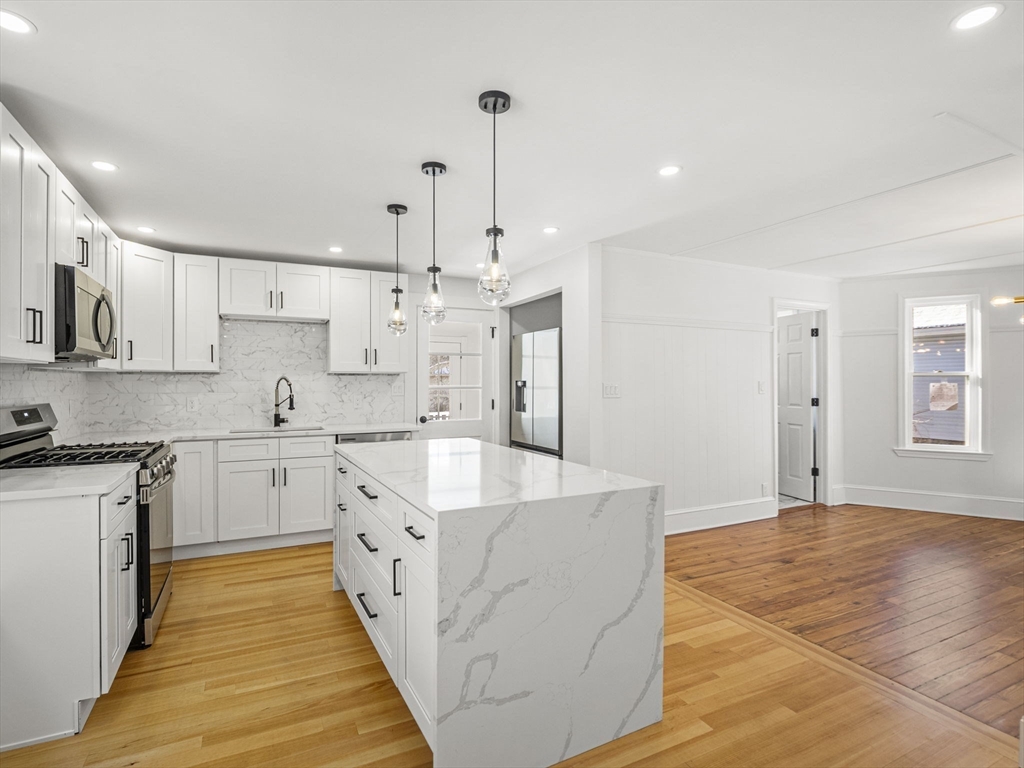 224 Pelham Street Methuen, MA 01844 - Photo 10 of 40 a large kitchen with stainless steel appliances kitchen island granite countertop a sink and a stove