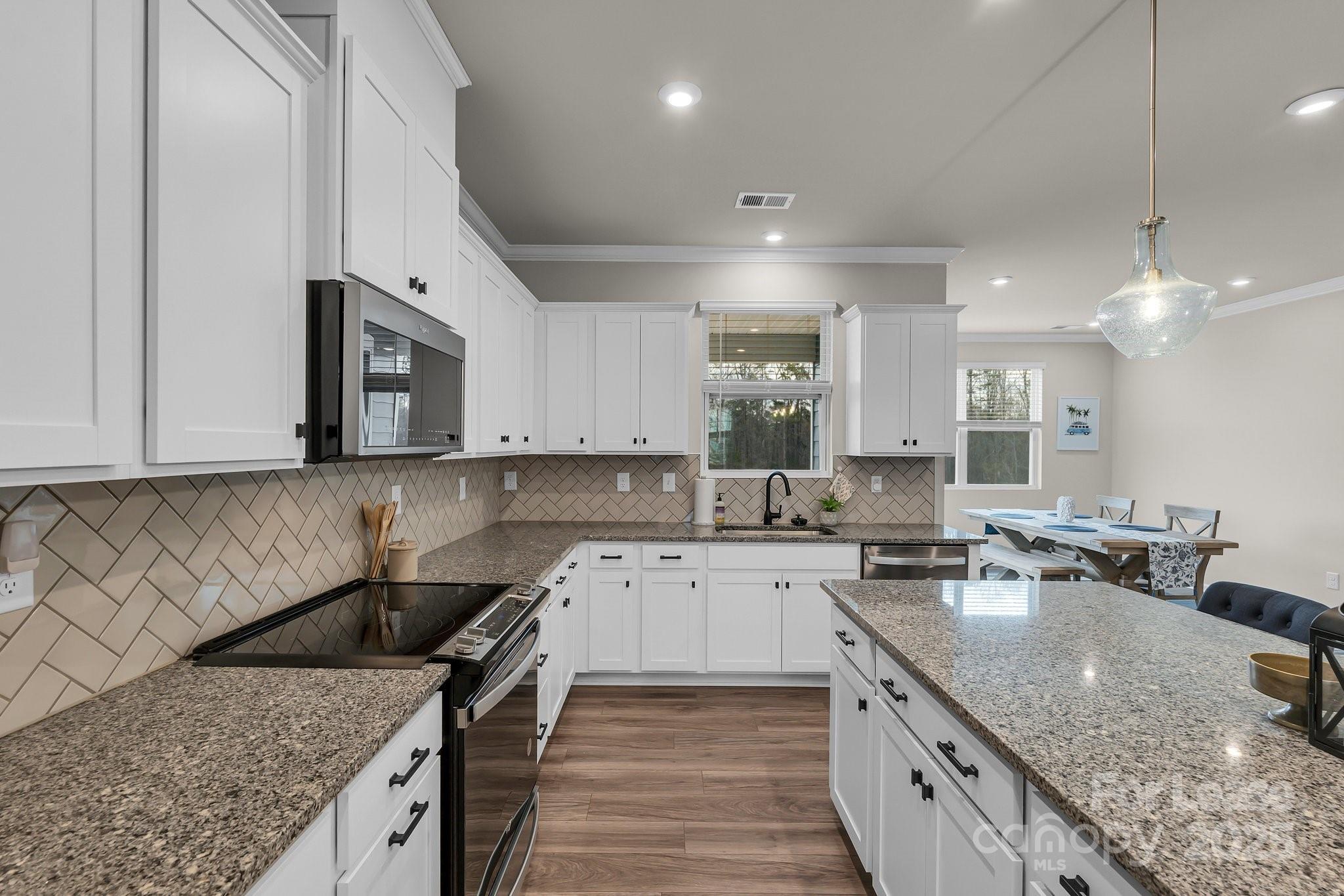 16764 Summers Walk Boulevard Davidson, NC 28036 - Photo 11 of 26 a kitchen with a sink stove and cabinets