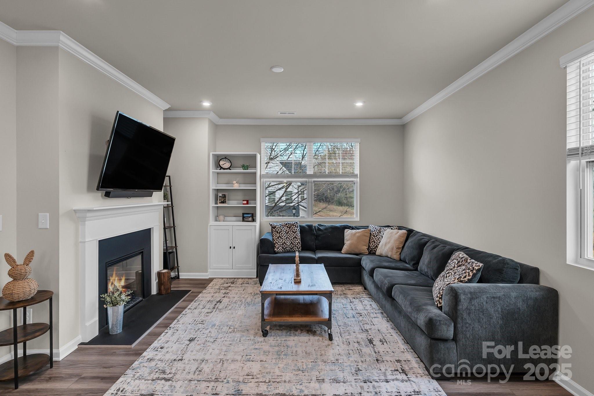 16764 Summers Walk Boulevard Davidson, NC 28036 - Photo 13 of 26 a living room with furniture a flat screen tv and a fireplace