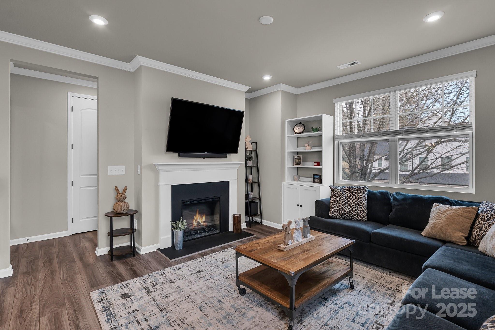 16764 Summers Walk Boulevard Davidson, NC 28036 - Photo 15 of 26 a living room with furniture a flat screen tv and a fireplace