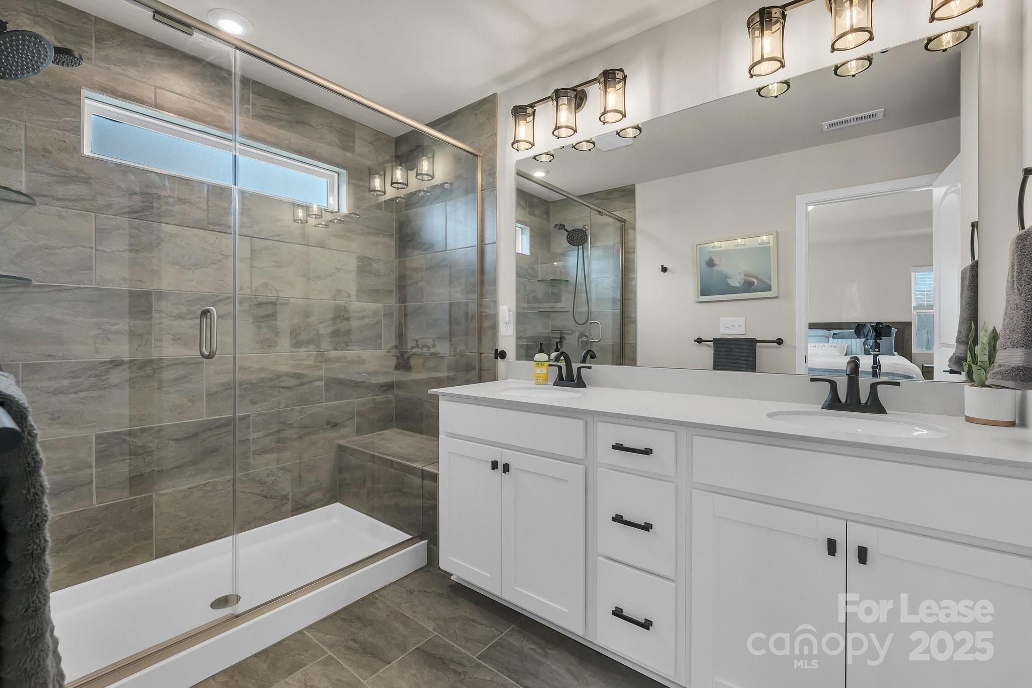16764 Summers Walk Boulevard Davidson, NC 28036 - Photo 21 of 26 a bathroom with a shower sink and mirror
