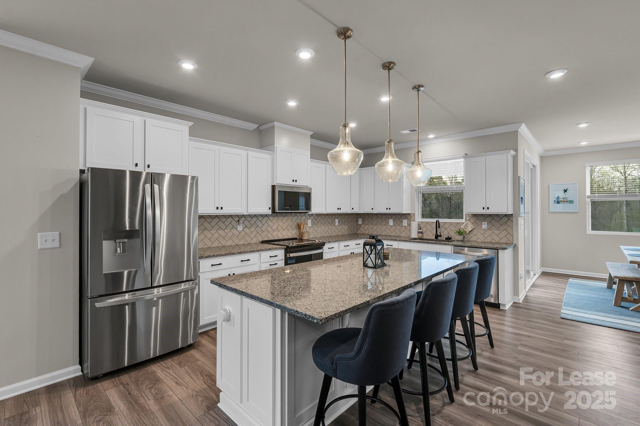 16764 Summers Walk Boulevard Davidson, NC 28036 - Photo 10 of 26 a large kitchen with a table and chairs