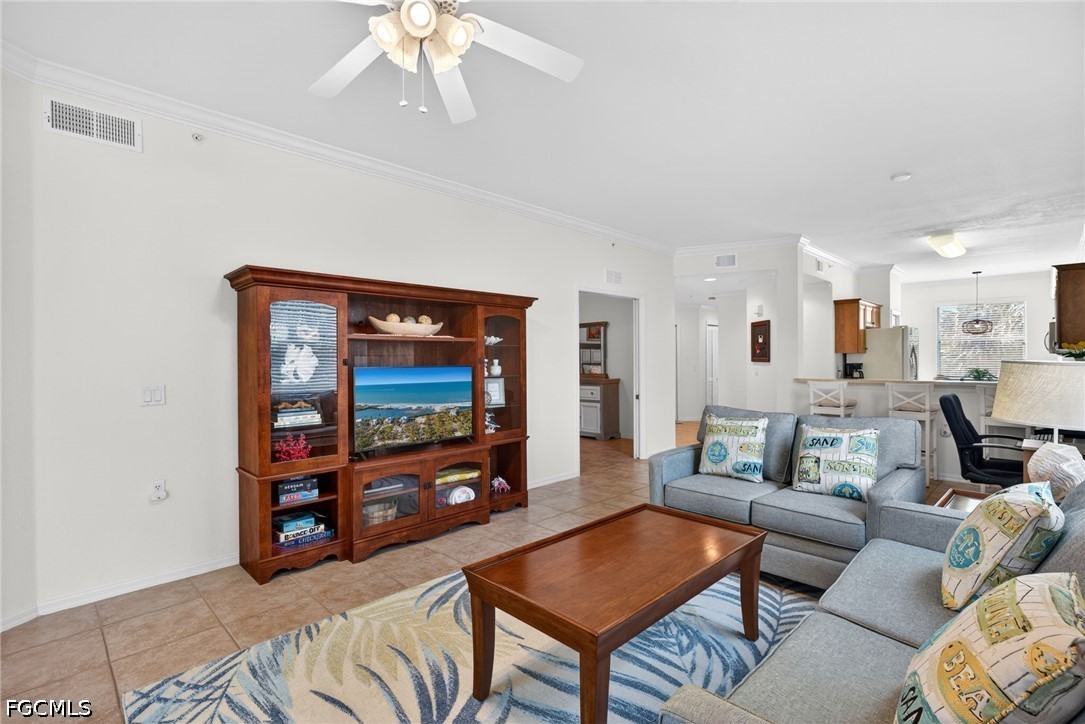 8251 Pathfinder Loop, Unit 621 Fort Myers, FL 33919 - Photo 12 of 30 a living room with furniture and a flat screen tv