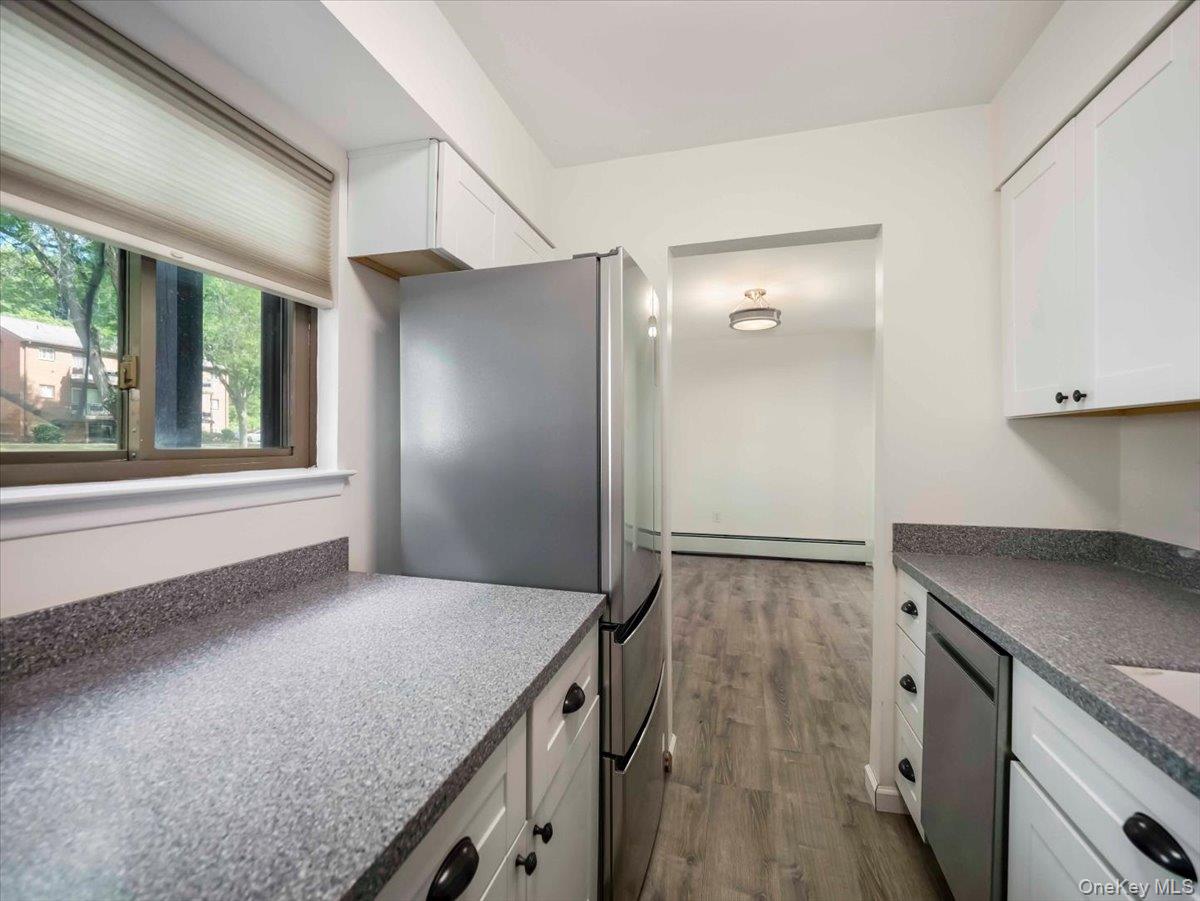27 Tanager Road, Unit 2702 Monroe, NY 10950 - Photo 4 of 35 Kitchen featuring white cabinetry, speckled countertops, and stainless steel appliances