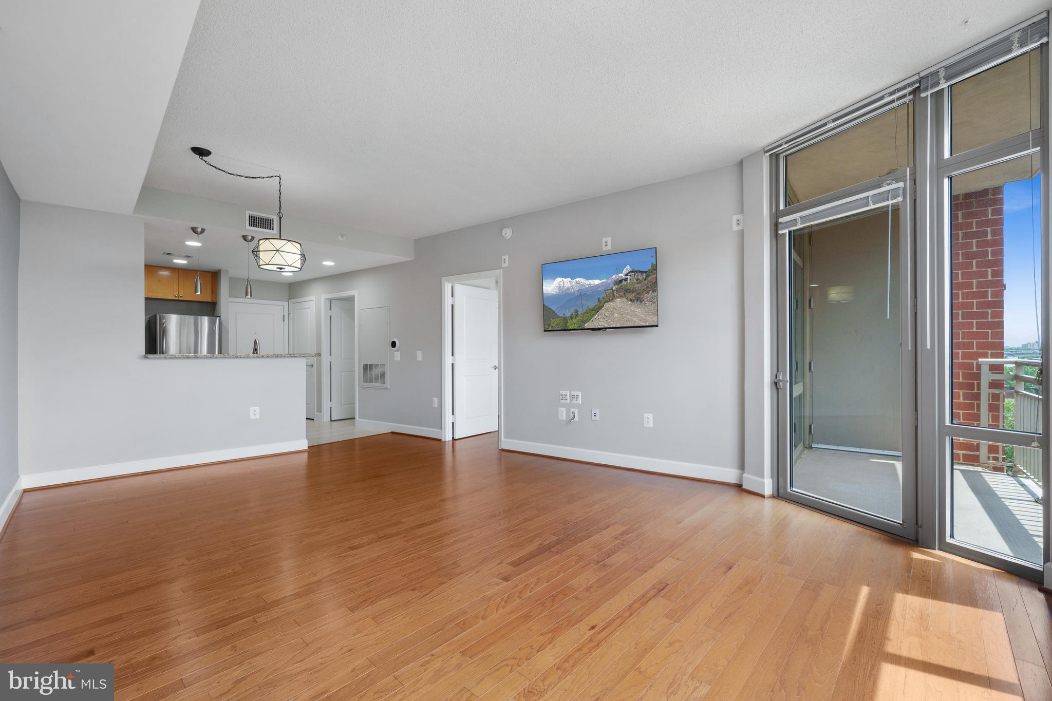 3600 South Glebe Road, Unit 526W Arlington, VA 22202 - Photo 11 of 34 wooden floor in an empty room with a window