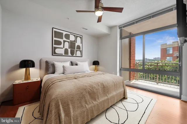 a spacious bedroom with a bed and glass door