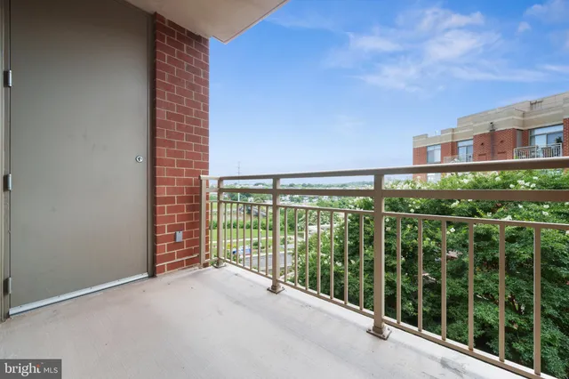 a view of a balcony with floor to ceiling windows with wooden floor