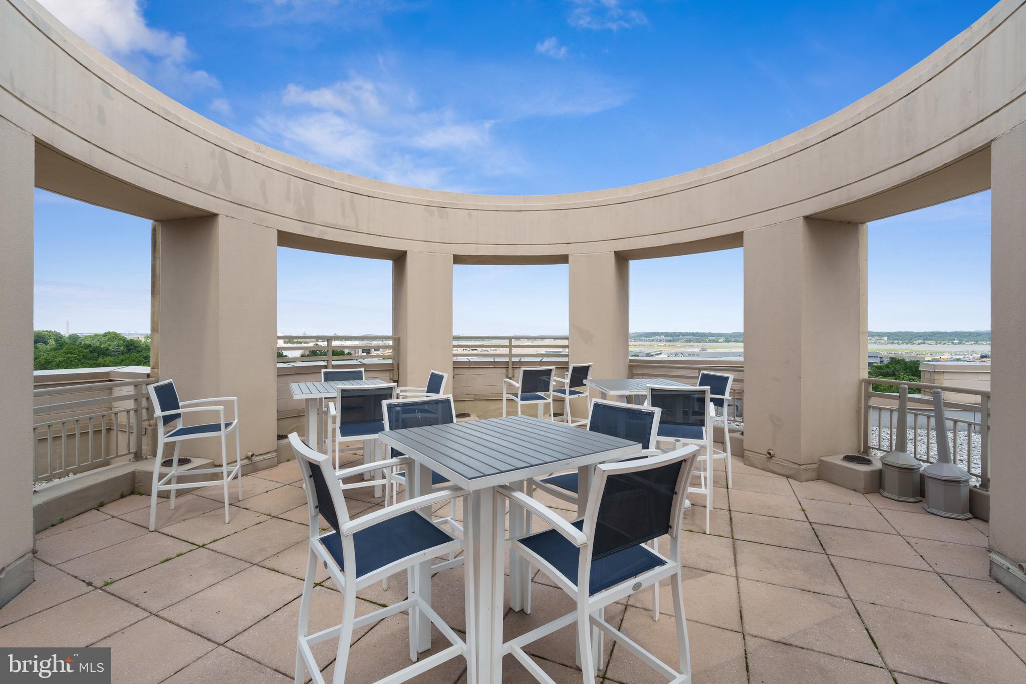 3600 South Glebe Road, Unit 526W Arlington, VA 22202 - Photo 29 of 34 a view of a dining room and livingroom with furniture wooden floor and a rug