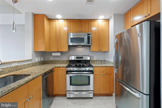 a kitchen with a refrigerator sink and stove