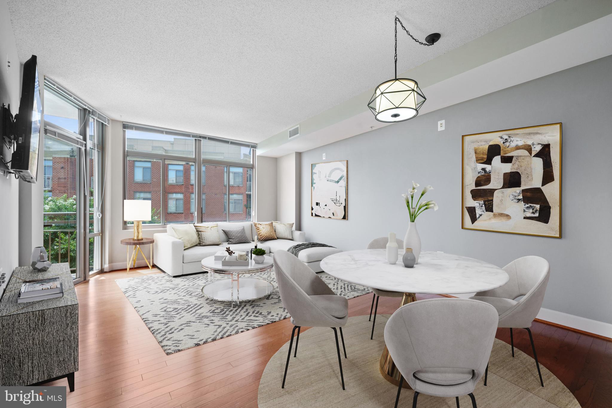 3600 South Glebe Road, Unit 526W Arlington, VA 22202 - Photo 7 of 34 a dining room with wooden floor a chandelier a wooden table and chairs