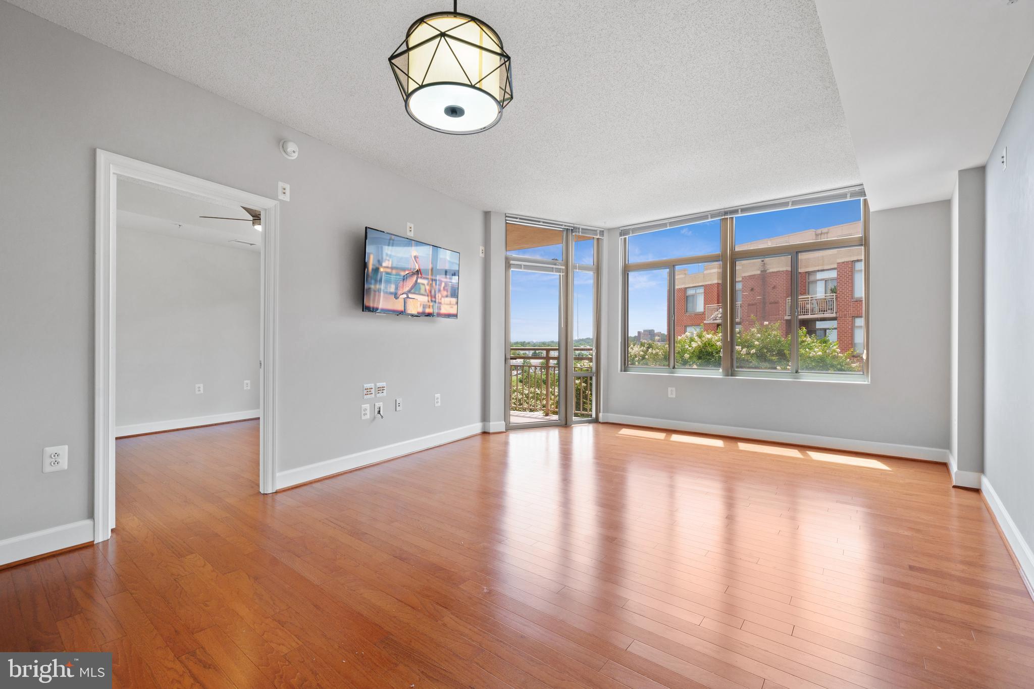 3600 South Glebe Road, Unit 526W Arlington, VA 22202 - Photo 9 of 34 a view of an empty room with wooden floor and a window