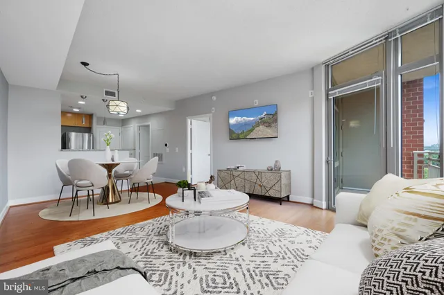 a living room with furniture and a chandelier