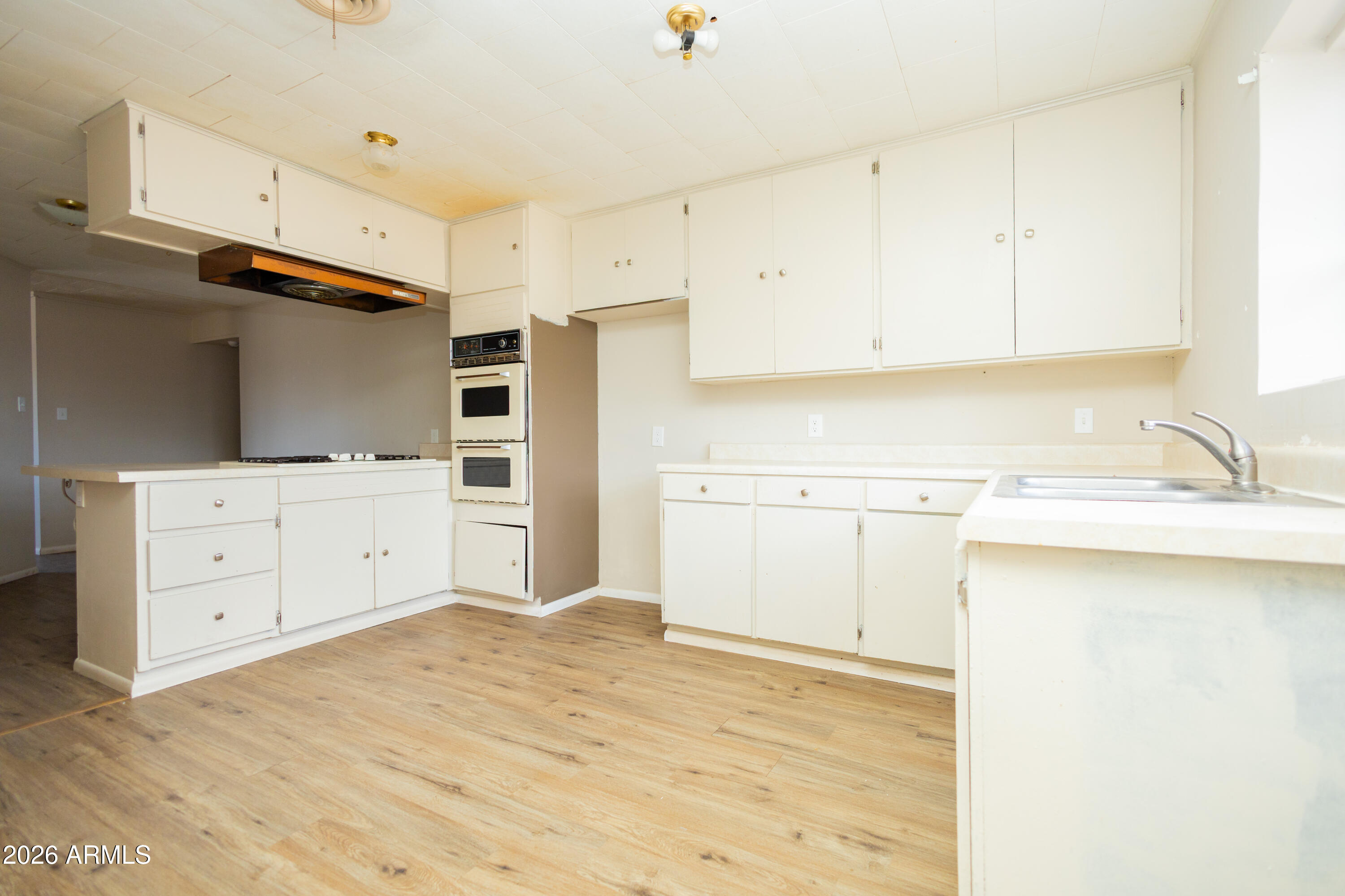 1626 11th Street Douglas, AZ 85607 - Photo 17 of 30 a kitchen with white cabinets and white appliances
