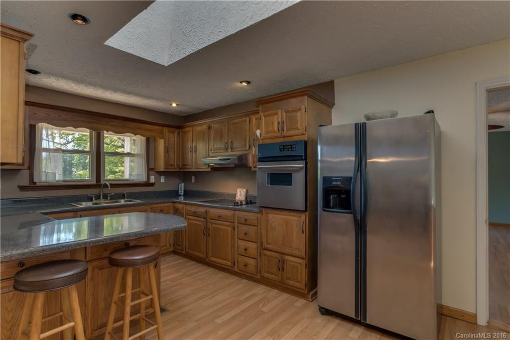 246 Clark Road Rutherfordton, NC 28139 - Photo 8 of 24 a kitchen with stainless steel appliances granite countertop a refrigerator a sink and a stove