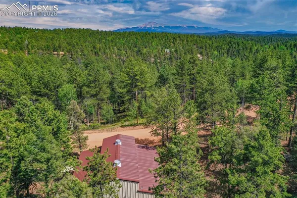 a view of a big yard with lots of green space and mountain view