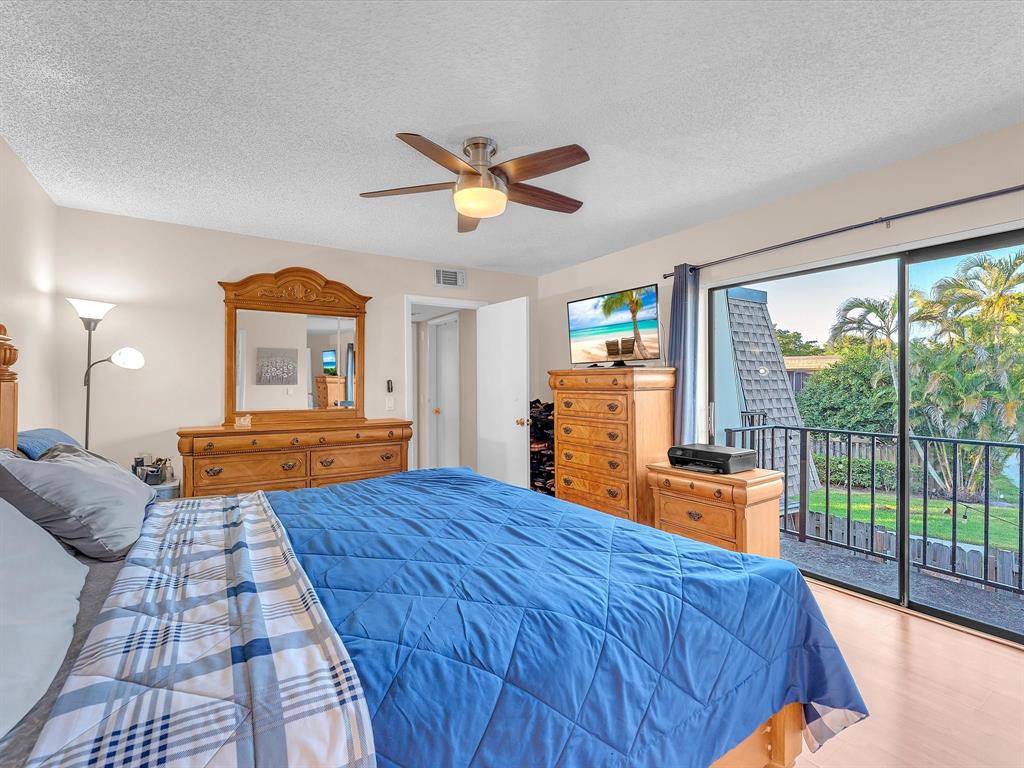 2947 Southwest 22nd Circle, Unit 28D Delray Beach, FL 33445 - Photo 13 of 32 a bedroom with a large bed and a large window