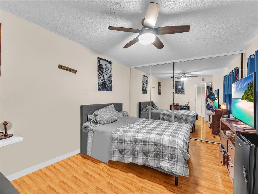 2947 Southwest 22nd Circle, Unit 28D Delray Beach, FL 33445 - Photo 17 of 32 a bedroom with bed and flat screen tv