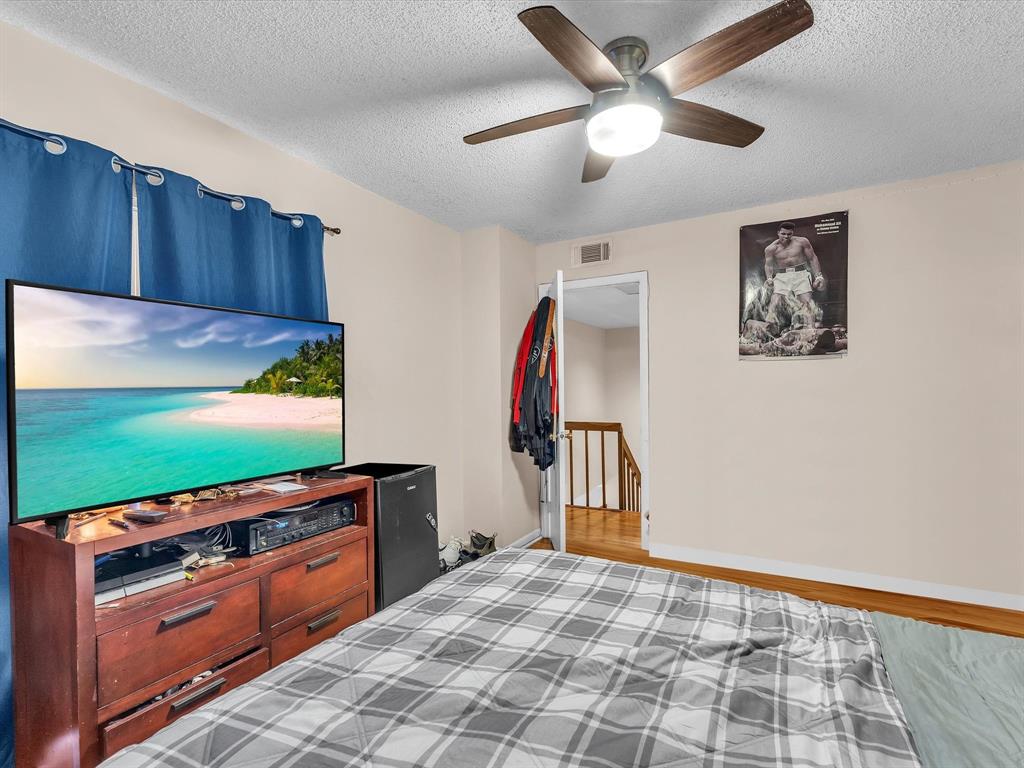2947 Southwest 22nd Circle, Unit 28D Delray Beach, FL 33445 - Photo 18 of 32 a view of a room with wooden floor ceiling fan and windows