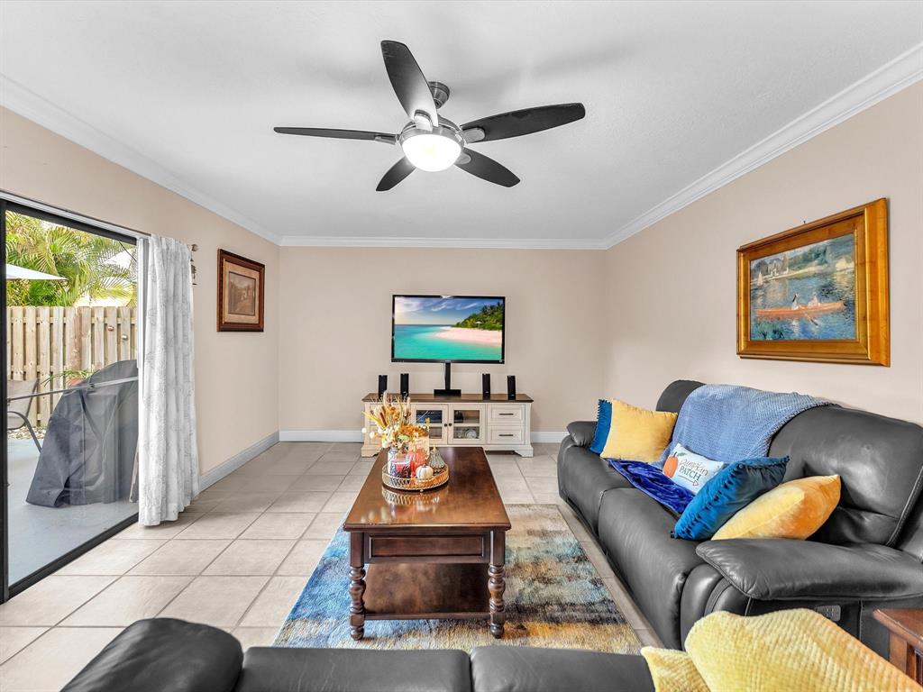 2947 Southwest 22nd Circle, Unit 28D Delray Beach, FL 33445 - Photo 2 of 32 a living room with furniture and a ceiling fan