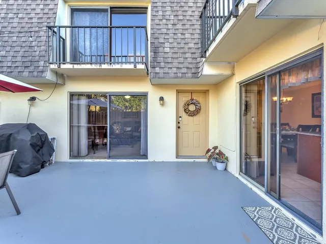 a view of a house with a yard patio and furniture
