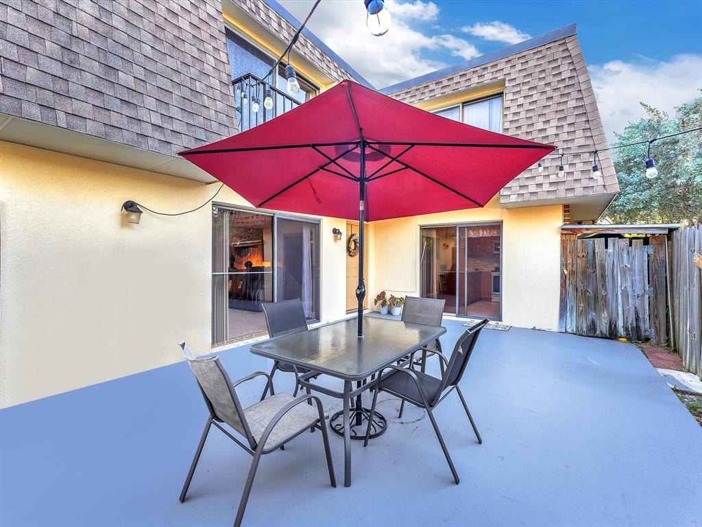 2947 Southwest 22nd Circle, Unit 28D Delray Beach, FL 33445 - Photo 25 of 32 a view of a house with a yard patio and furniture