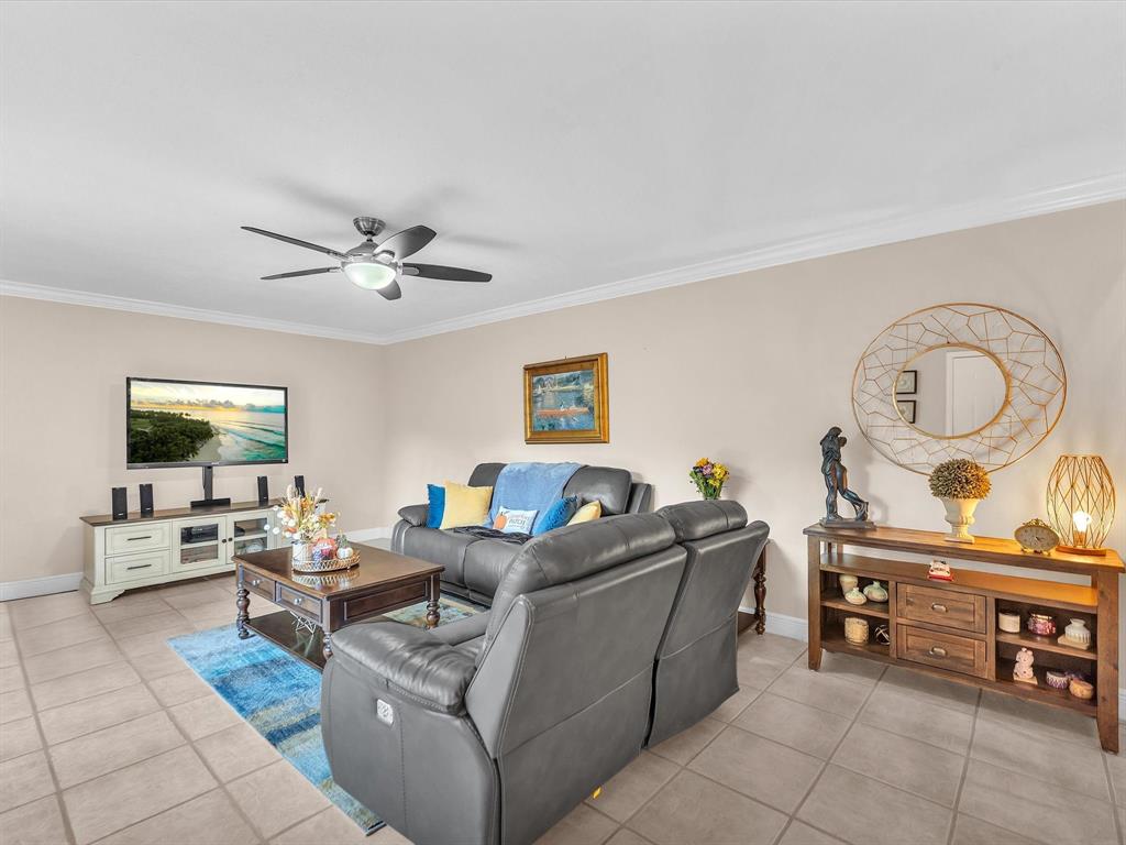 2947 Southwest 22nd Circle, Unit 28D Delray Beach, FL 33445 - Photo 3 of 32 a living room with furniture and a flat screen tv
