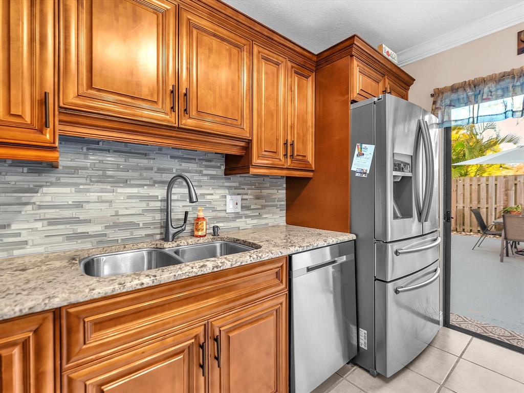 2947 Southwest 22nd Circle, Unit 28D Delray Beach, FL 33445 - Photo 7 of 32 a kitchen with stainless steel appliances granite countertop a refrigerator and a sink