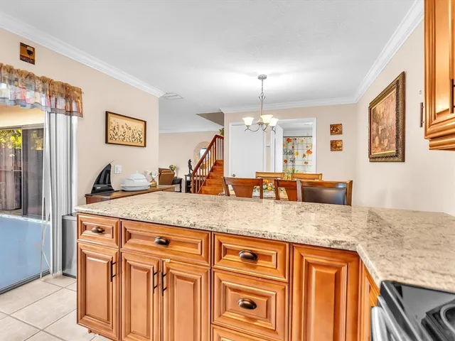 a kitchen with stainless steel appliances granite countertop a sink and a refrigerator