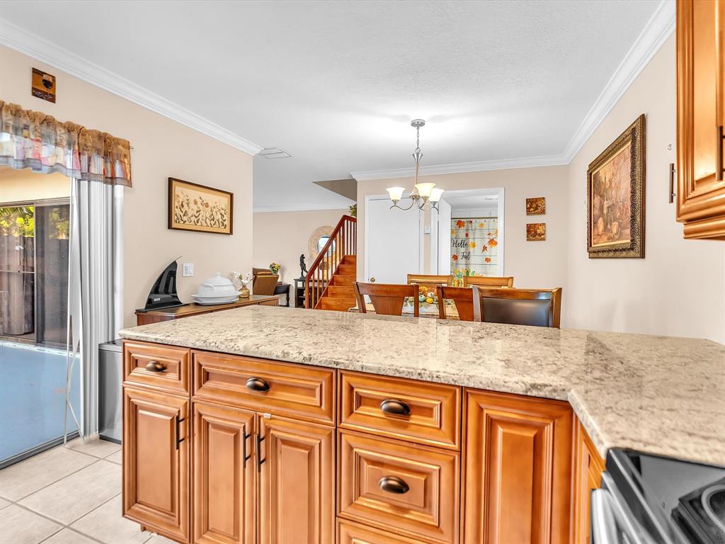 2947 Southwest 22nd Circle, Unit 28D Delray Beach, FL 33445 - Photo 9 of 32 a kitchen with stainless steel appliances granite countertop a sink and a refrigerator