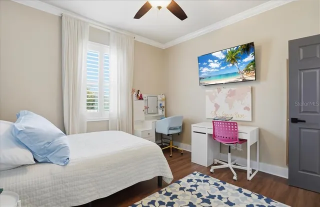 a bedroom with a large bed and a chandelier