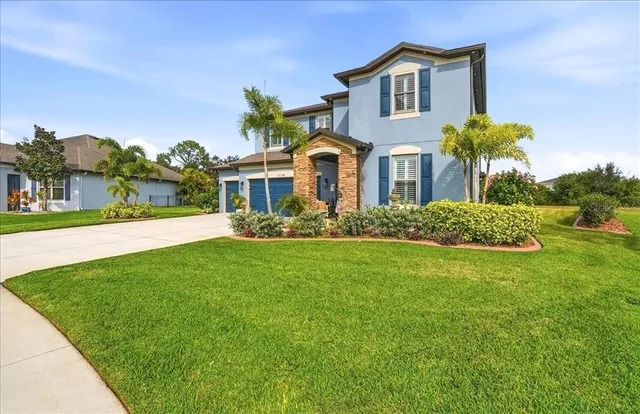 a front view of house with yard and green space