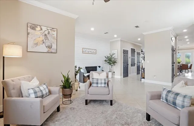 a dining room with furniture and a potted plant