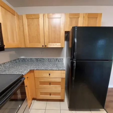 a kitchen with a refrigerator and cabinets