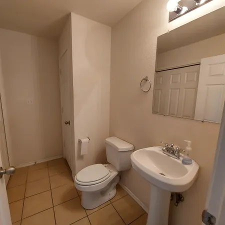 a bathroom with a sink toilet and a mirror