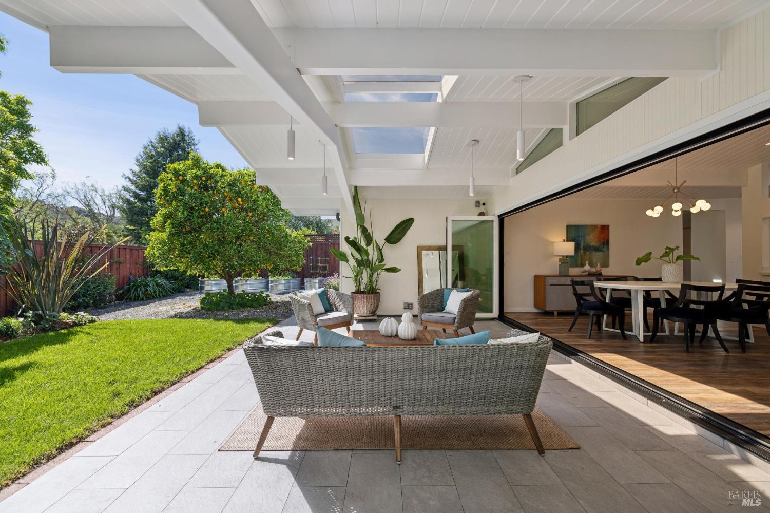 839 Greenberry Lane San Rafael, CA 94903 - Photo 2 of 57 a view of a patio with dining table and chairs with plants and wooden fence