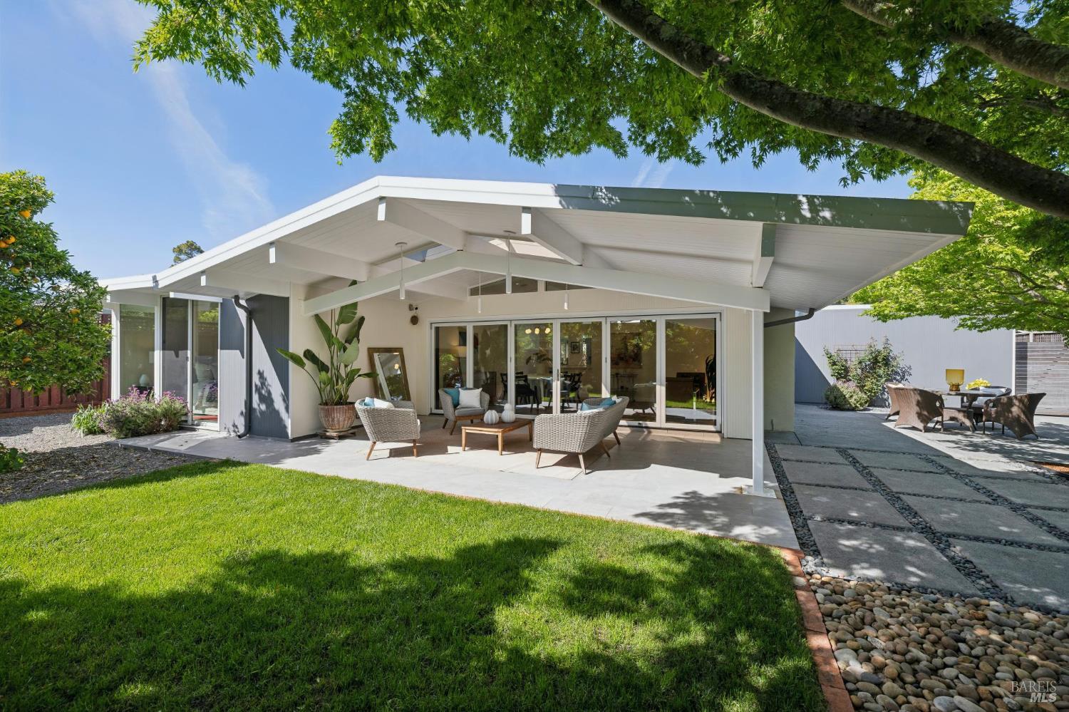 839 Greenberry Lane San Rafael, CA 94903 - Photo 45 of 57 a view of a patio with table and chairs under an umbrella with large trees