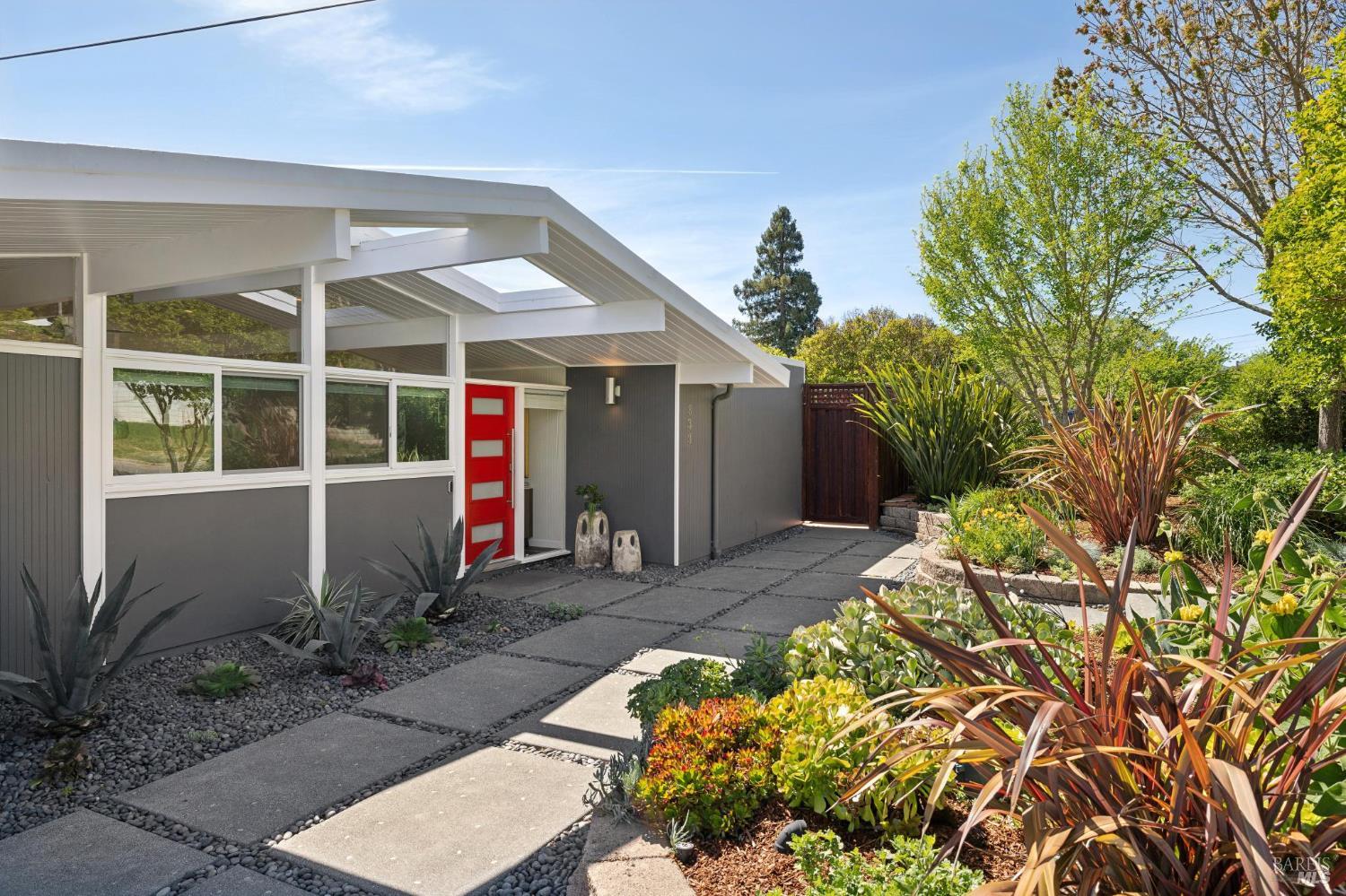 839 Greenberry Lane San Rafael, CA 94903 - Photo 53 of 57 a view of a house with large windows and flower plants