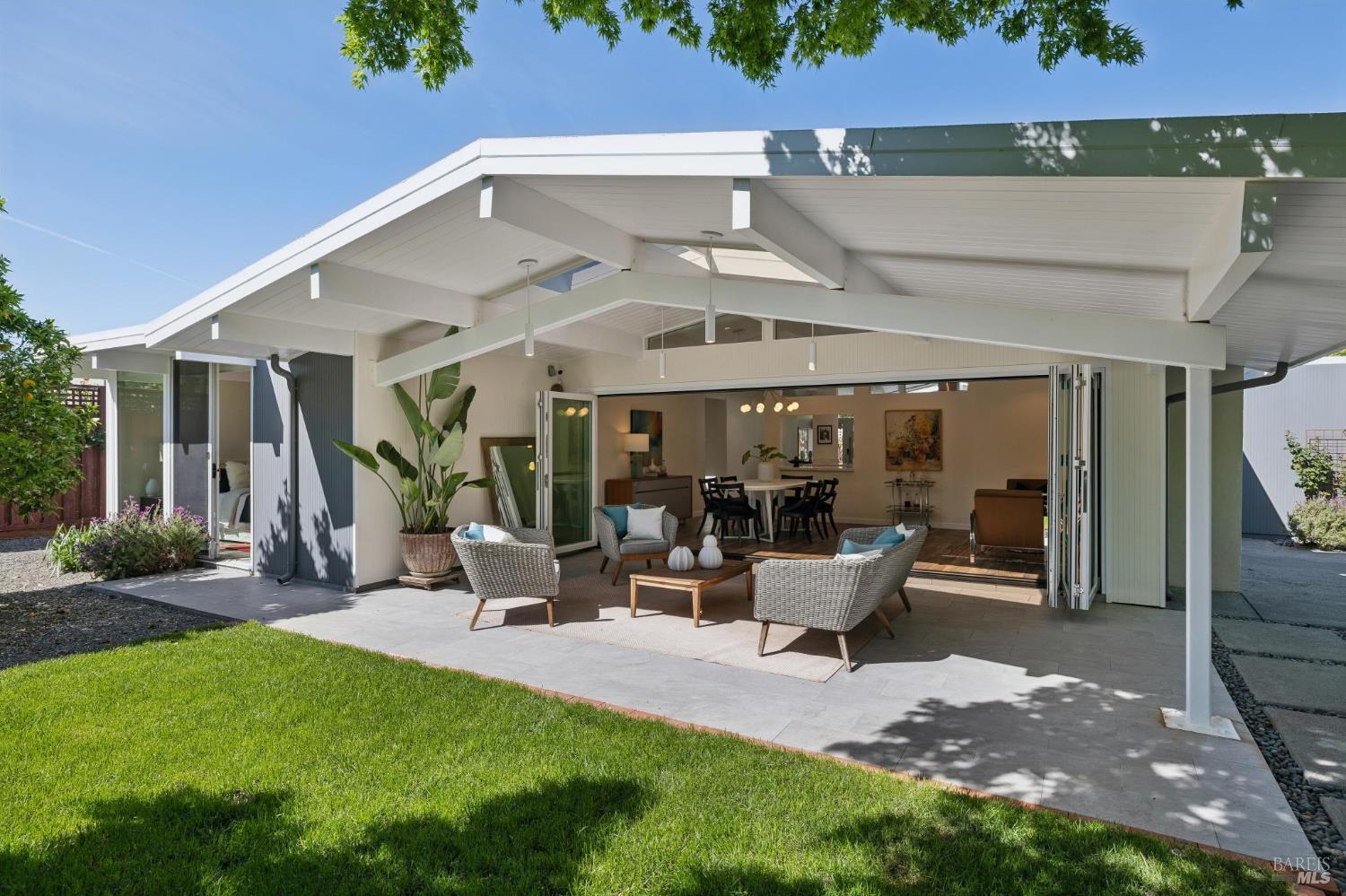 839 Greenberry Lane San Rafael, CA 94903 - Photo 7 of 57 a view of a patio with table and chairs potted plants and floor to ceiling window