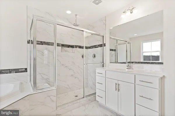 a bathroom with a double vanity sink a mirror and a shower